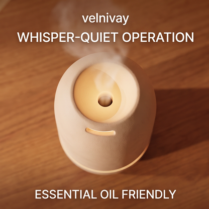 Close-up of CALMIRAY diffuser top releasing mist with warm glow for relaxation