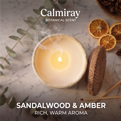 Top view of lit CALMIRAY Botanical Scent candle with wood lid, rich warm sandalwood and amber aroma